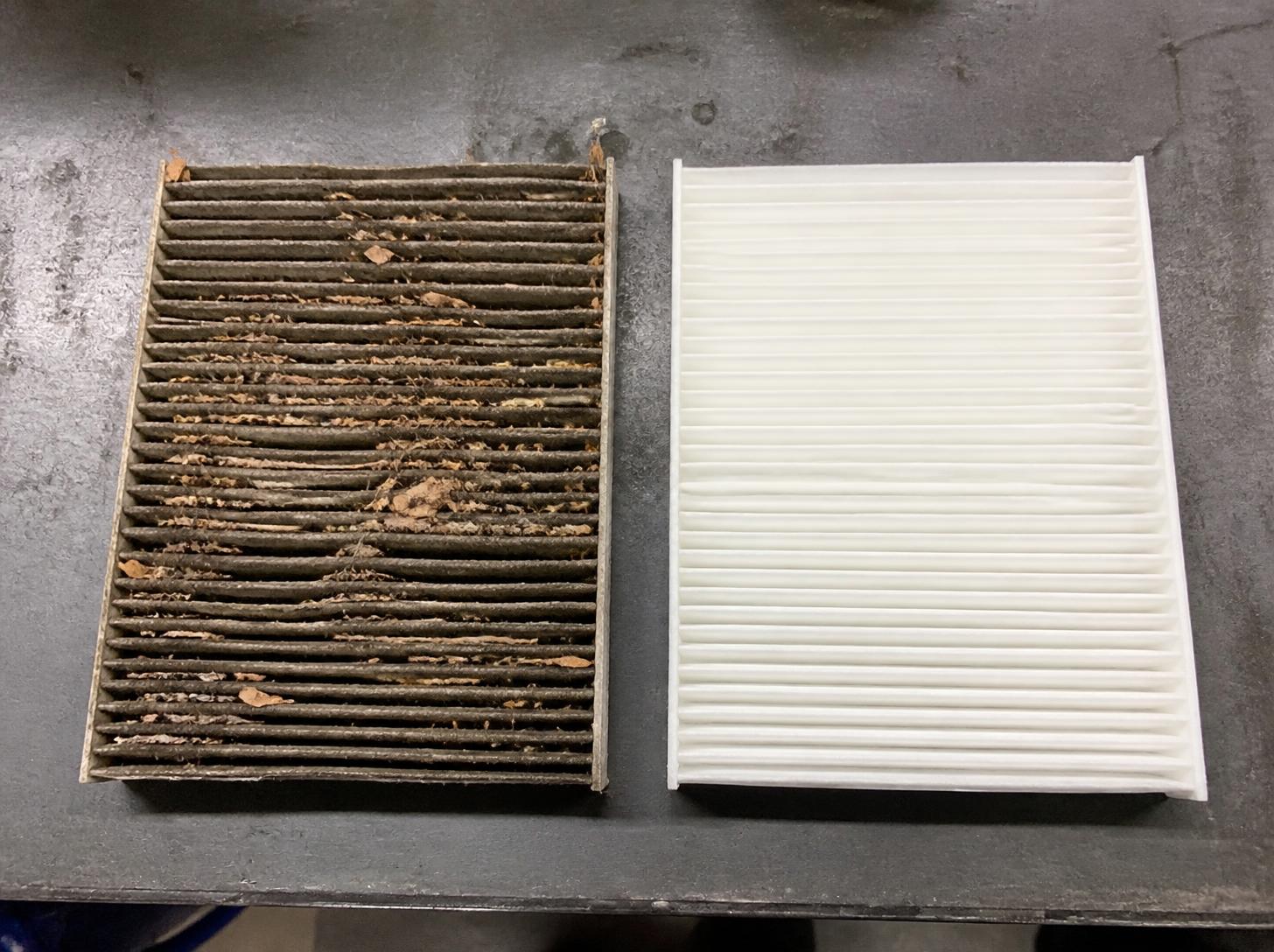 Dirty cabin air filter next to a new one